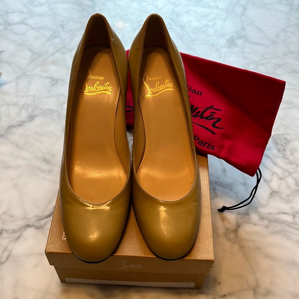 Never worn Christian Louboutin tan/beige pumps with 2 1/2” heels. Rounded toe.